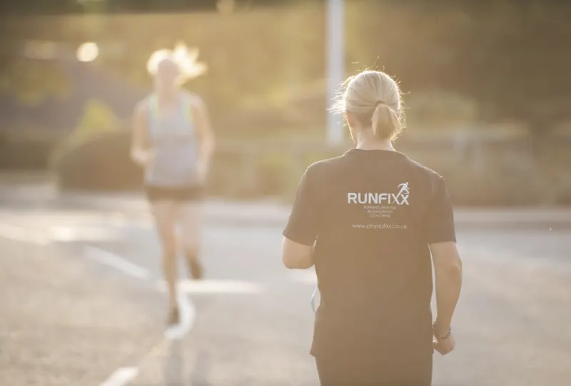 PhysioFixx: A runner's legs mid-stride on a track